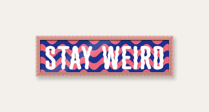 Stay Weird panoramic print in a pink bobbin frame