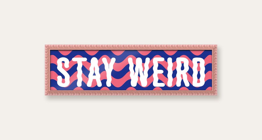 Stay Weird panoramic print in a pink bobbin frame
