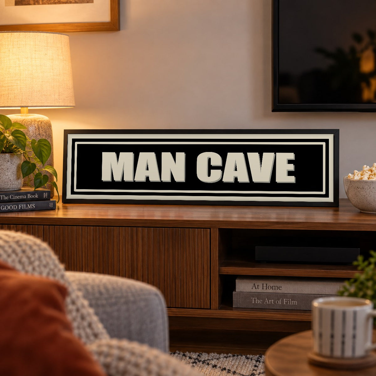Man Cave panoramic print in a black frame in a room setting
