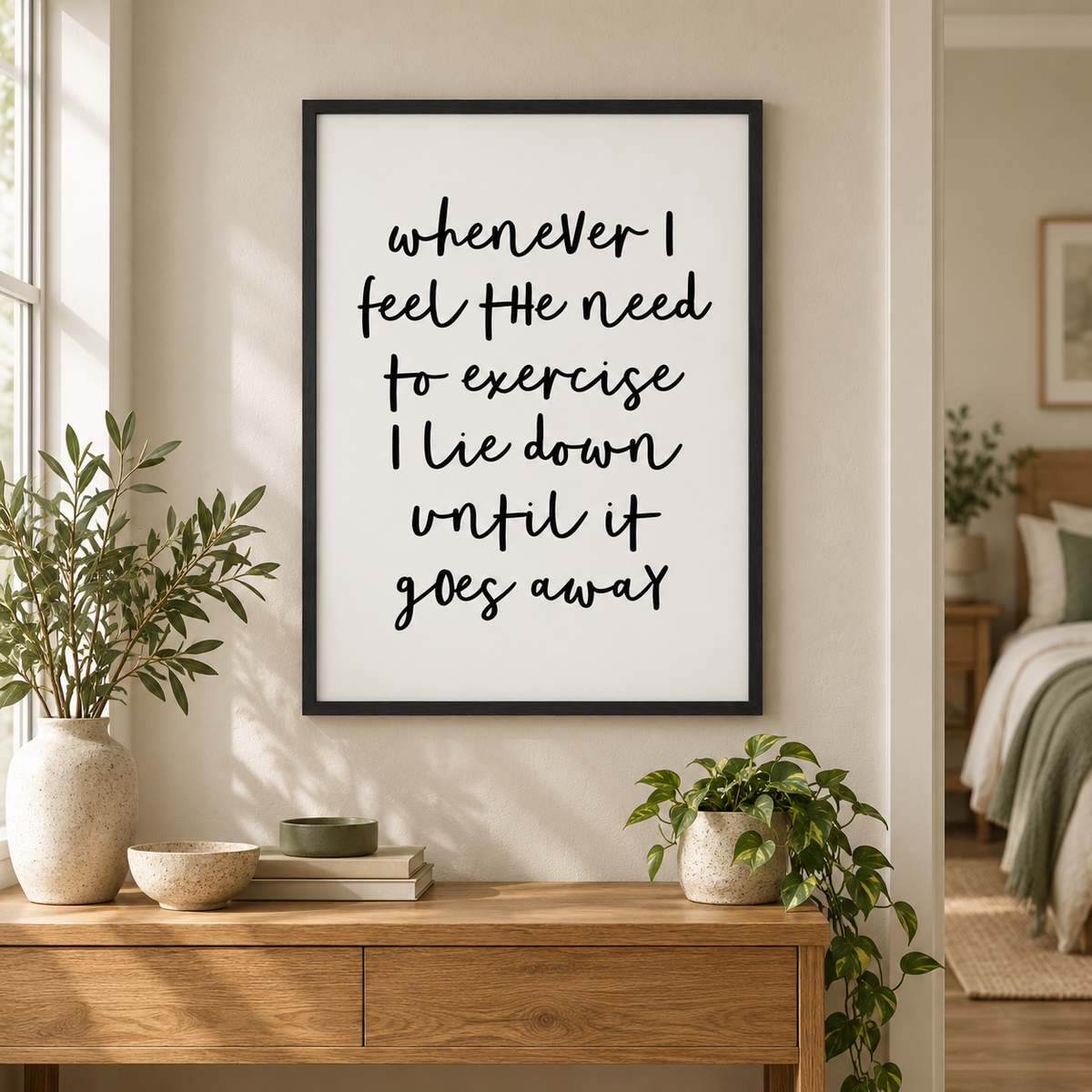 Whenever I Feel The Need To Exercise I Lie Down Until It Goes Away Print — wider room setting, black oak frame